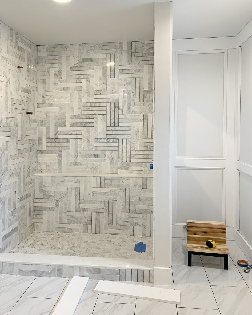 Unpainted Decorative Wall Molding In Master Bathroom With Tiled Marble Shower