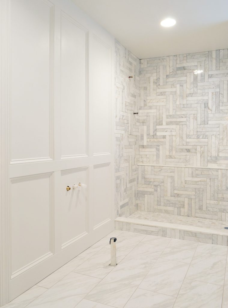 Master Bathroom Update With Decorative Wall Trim And Ungrouted Marble Shower