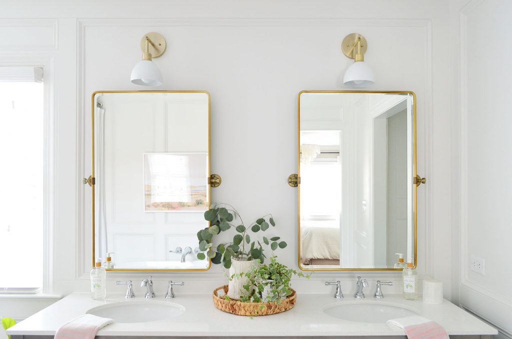 Brass Mirrors Over Vanity With Decorative Wall Molding Treatment Frame