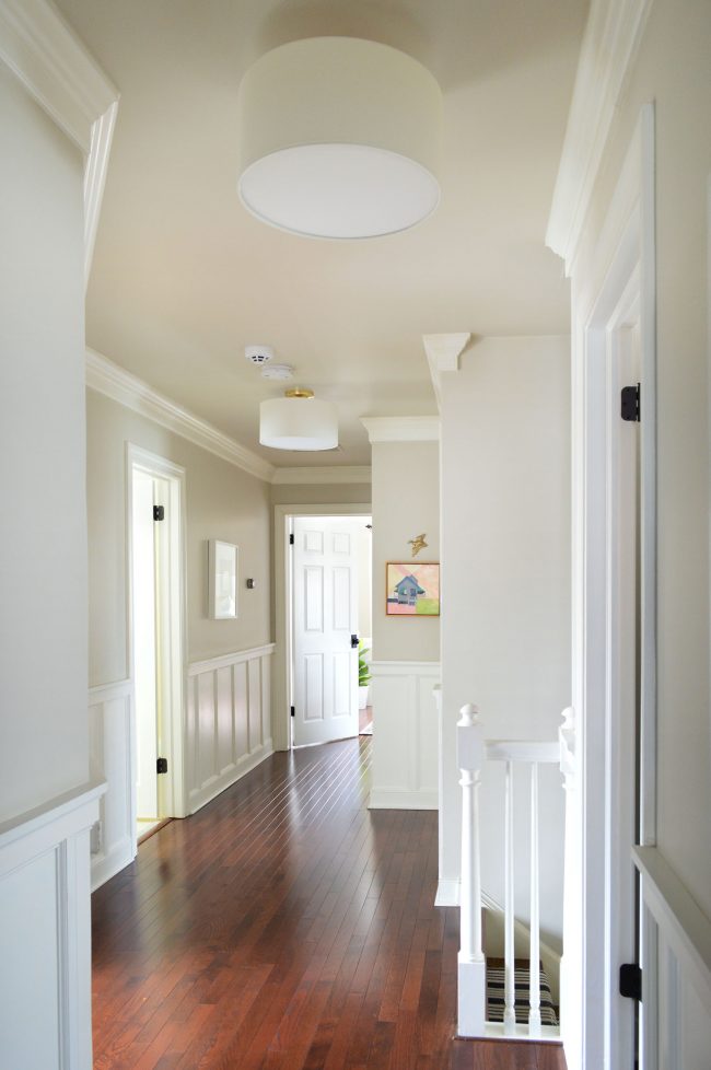 After Photo Of Hallway With Neutral Paint Wainscoting And Shaded Semi Flush Lights