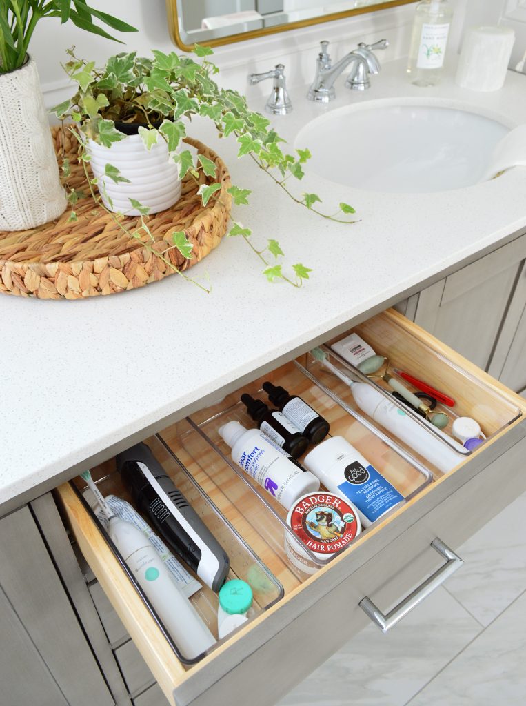 Open Drawer To Gray Bathroom Vanity Showing Organization Plastic Caddies