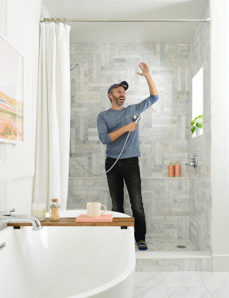 John Standing In Walk In Shower To Show Scale of Marble Tiled Wall