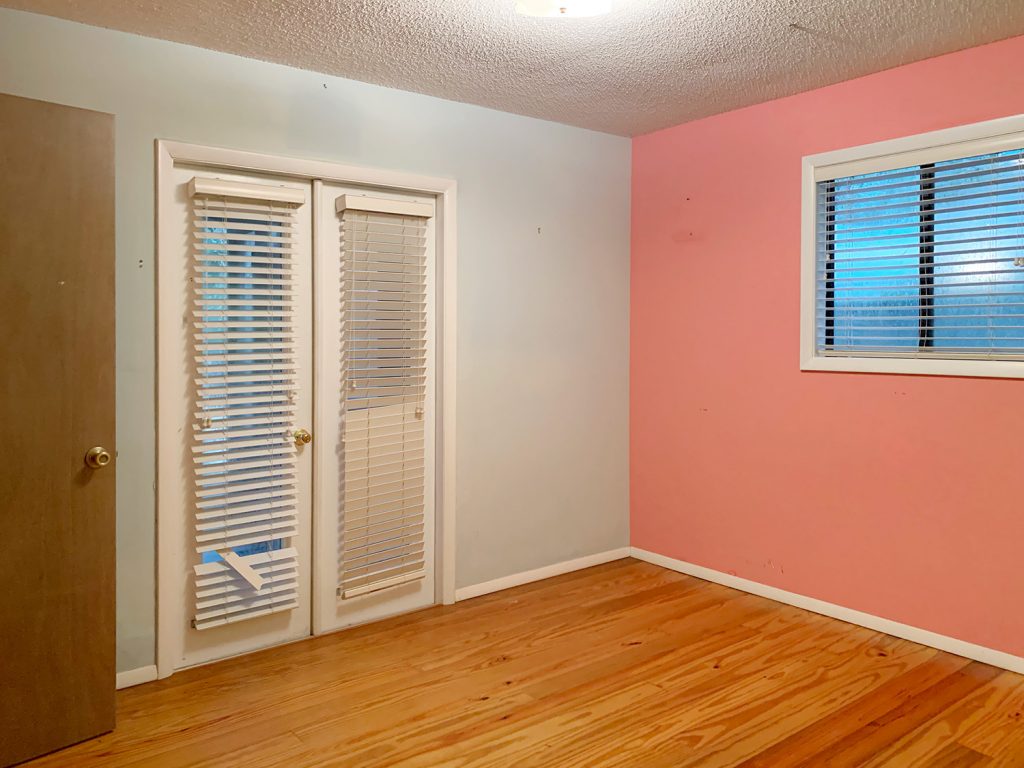 Before photo of daughters room with multicolored walls and popcorn ceilings