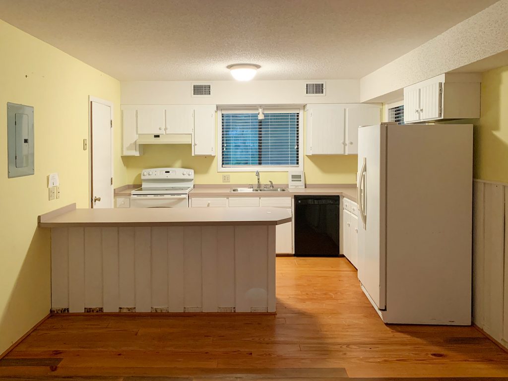 Before photo of small white kitchen with yellow walls