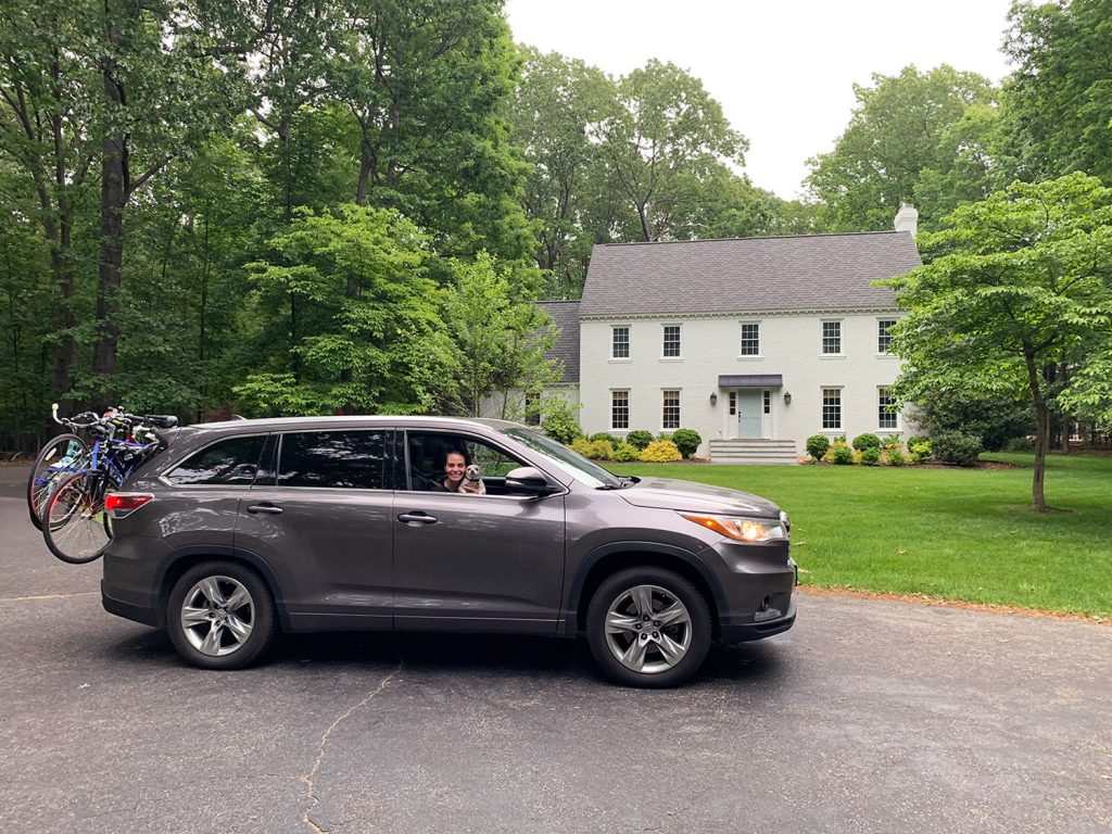 Toyota Highlander car parked in front of white brick house