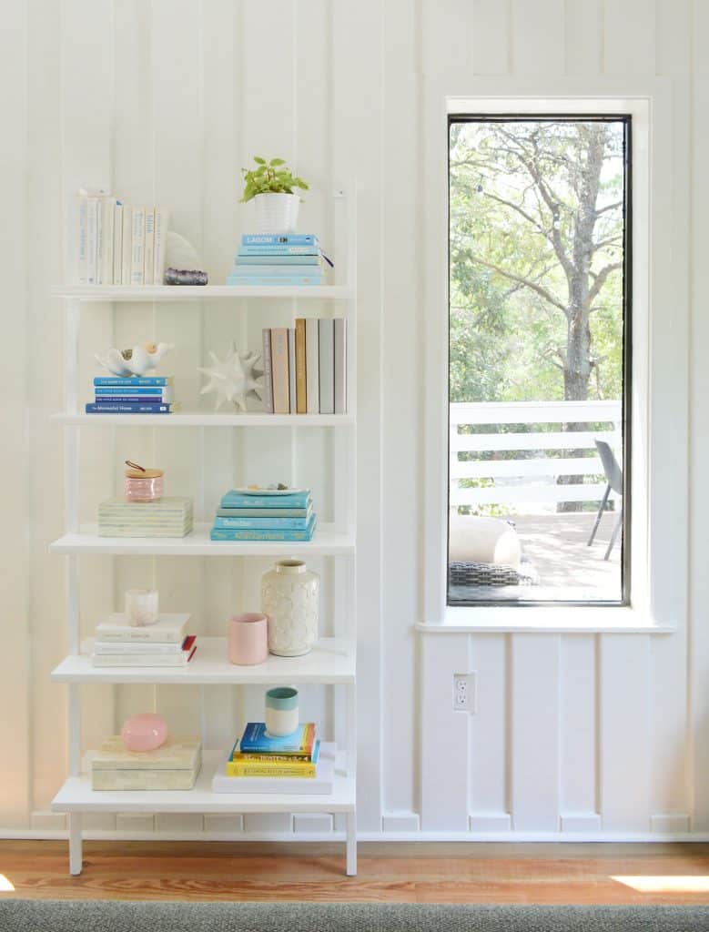 Tall Bookcase Against Wall In Beach Living Room