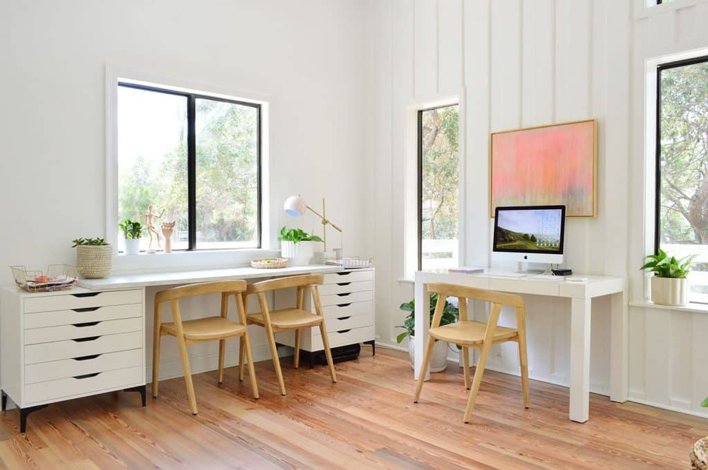 Mesa de arte longa e mesa de escritório na sala de estar praiana