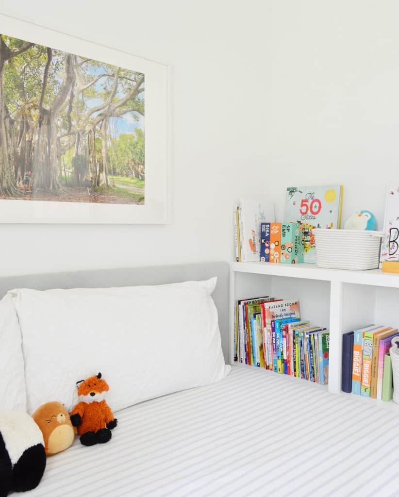 Boys bedroom with DIY fabric upholstered headboard and custom built-in bookcase footboard