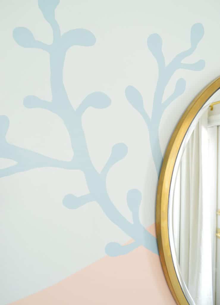 Blue coral shape painted onto abstract mural in beachy girls bedroom