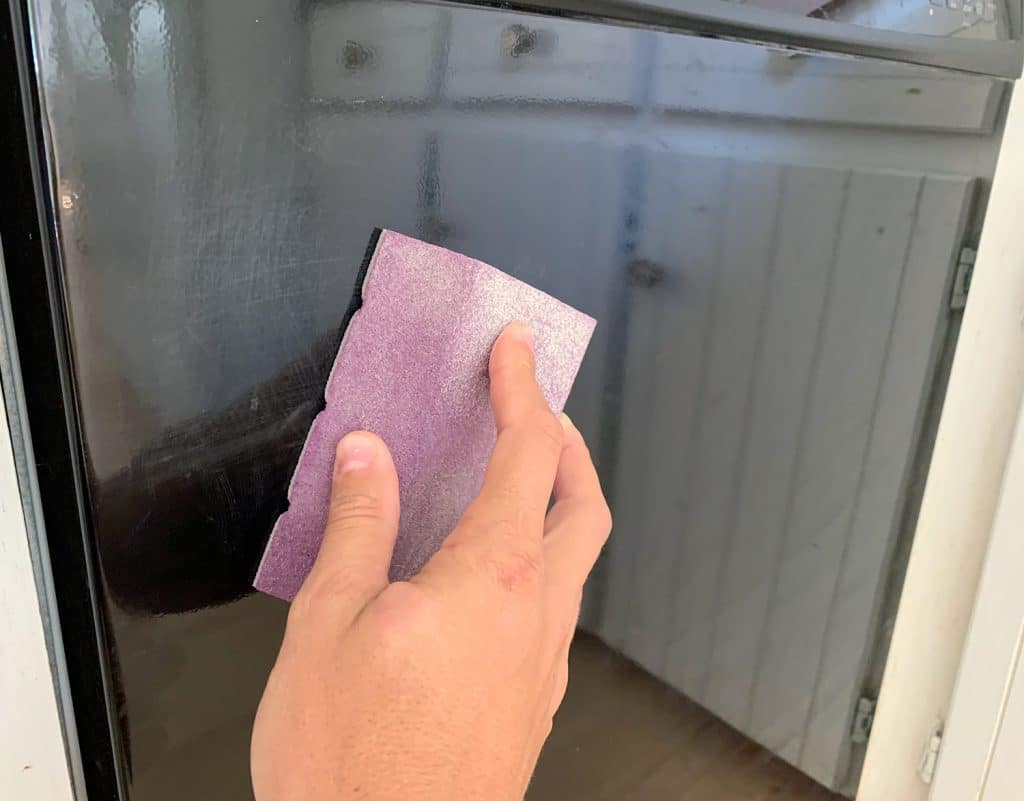 Sanding Front Of Black Dishwasher To Prepare For Painting