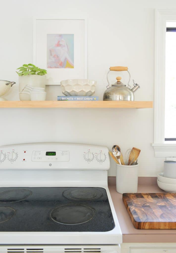 Simple Floating Shelf Constructed Over Old White Stove In Minimal Kitchen