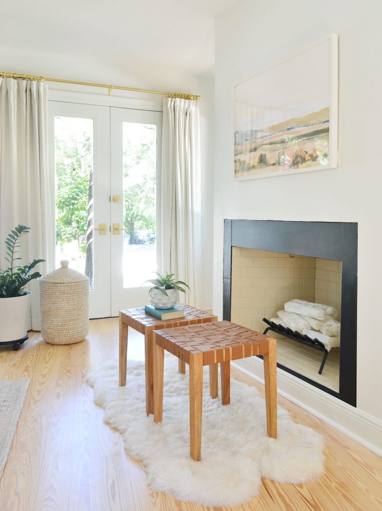 Bedroom fireplace with white crystal logs stacked like firewood and candles unlit