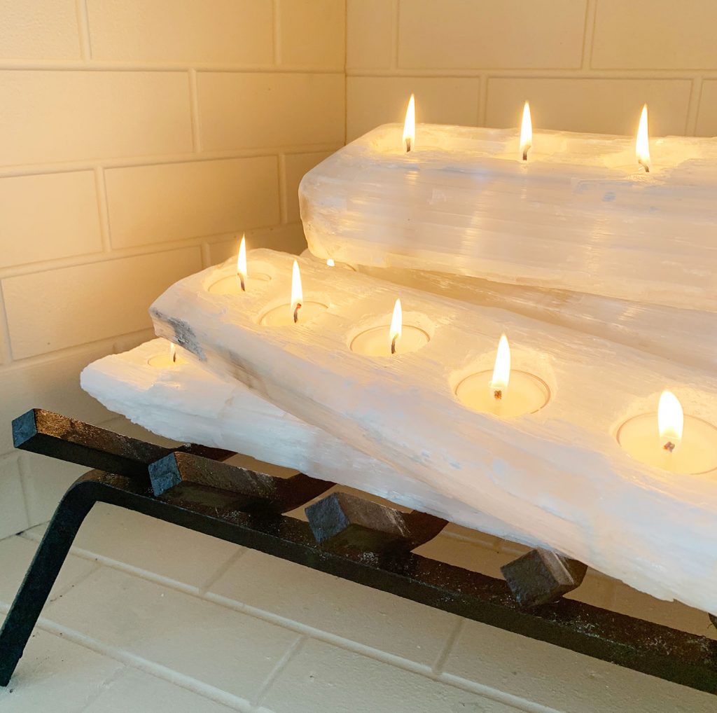 Close-up of tealight holder crystal logs with candles lit