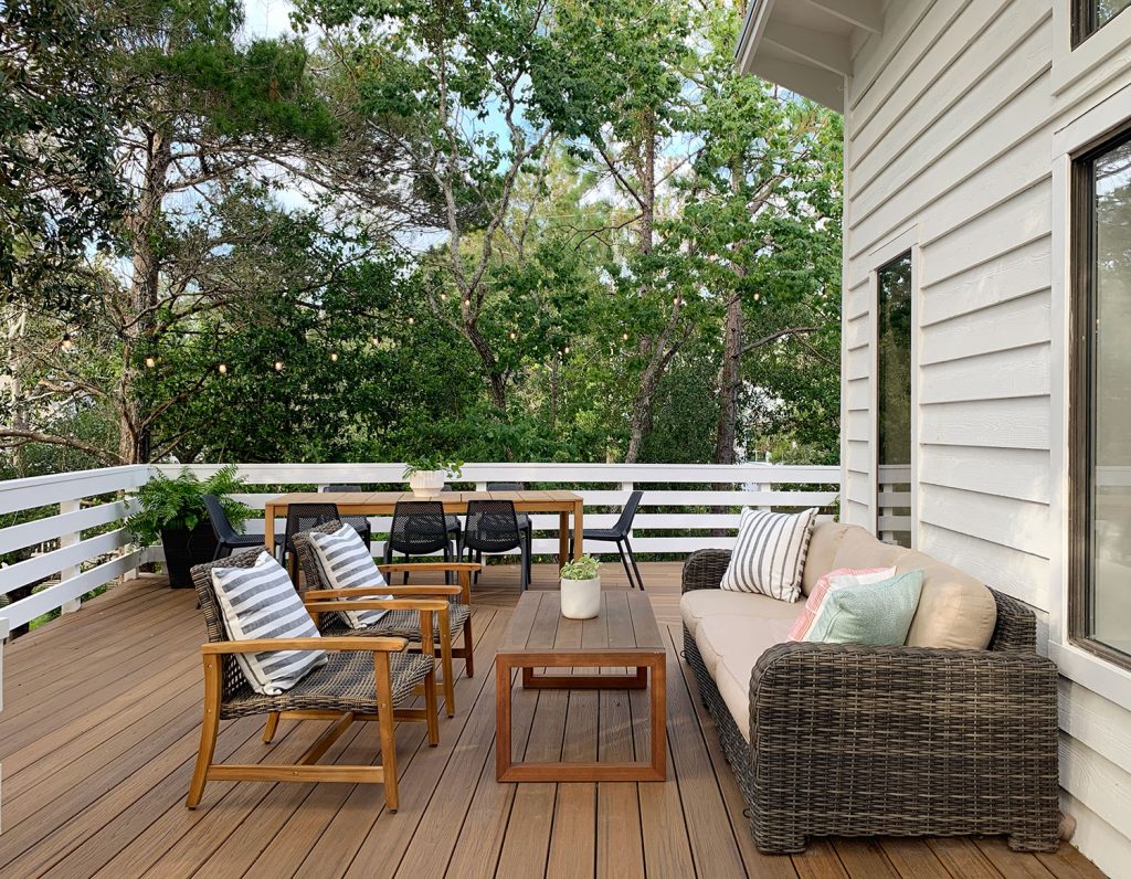 Deck Seating Area With Outdoor Couch Table And Two Woven Lounge Chairs