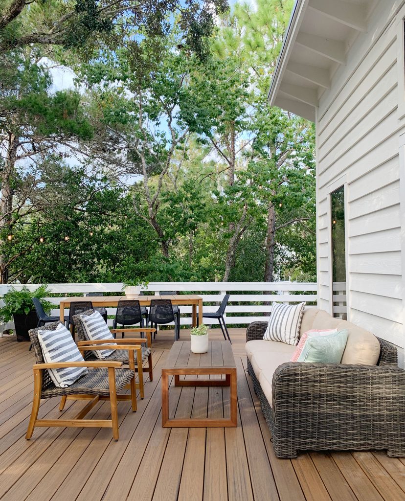 Deck Seating Area With Outdoor Couch Table And Two Woven Lounge Chairs