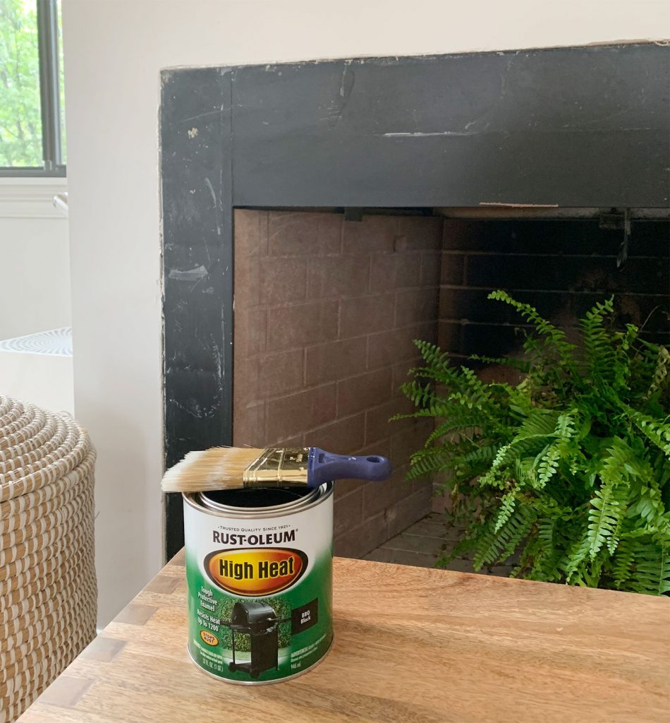 Can of Rust-Oleum High Heat black paint sitting in front of fireplace