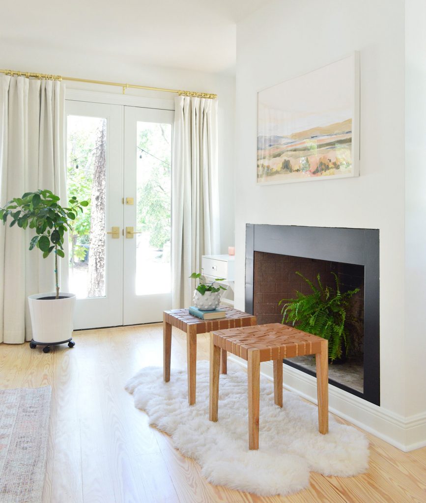 Bedroom fireplace with black border and fern in firebox