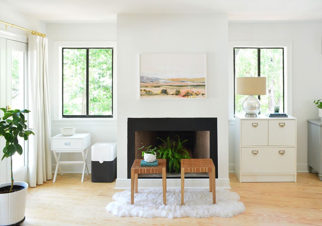 Bedroom fireplace shortly after moving with random furniture along the wall