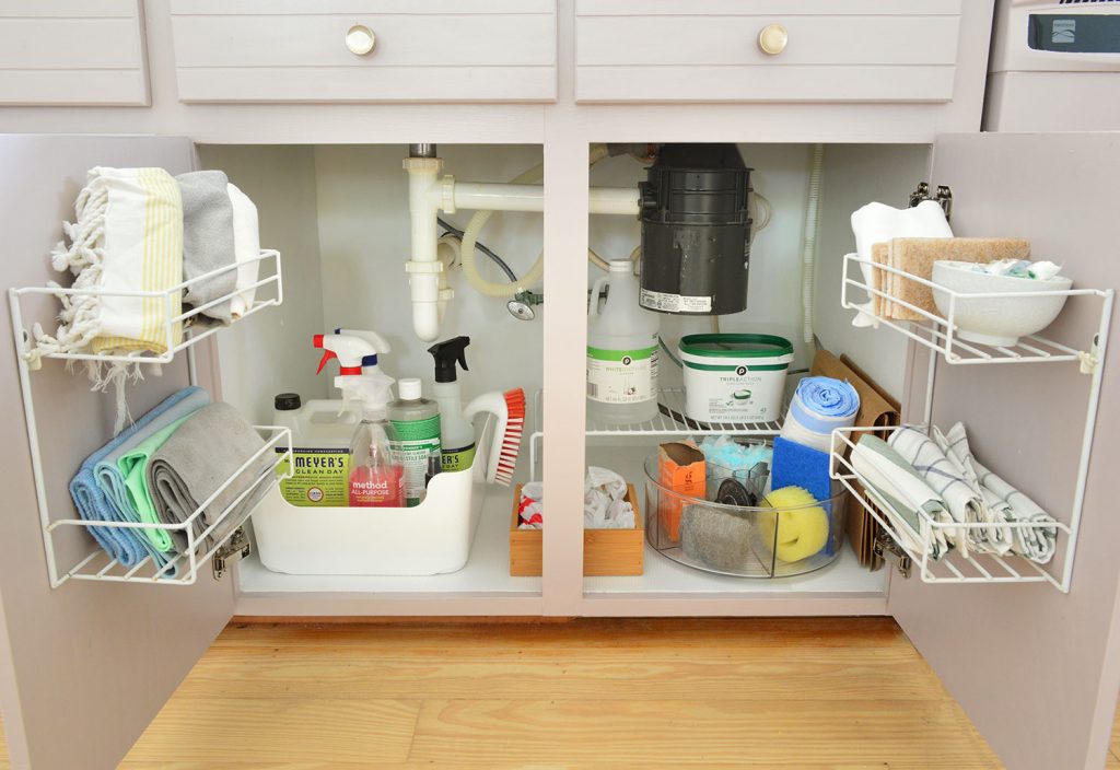 Under sink cleaning supply storage in kitchen with mauve cabinets