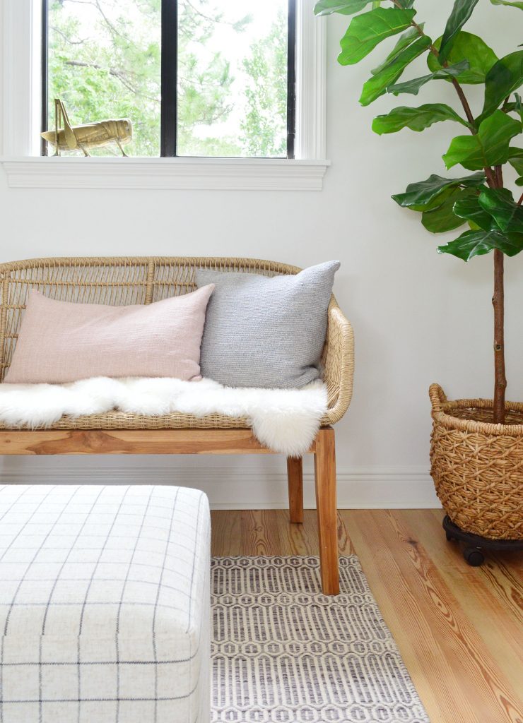 Front View Of Woven Bench With Fluffy Base Pillows And Fig Tree
