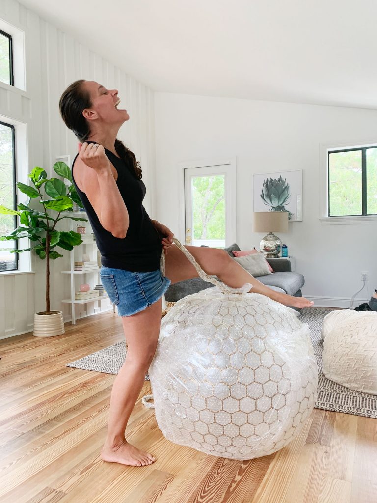 Sherry Pretending To Reenact Miley Cyrus Wrecking Ball On Large Capiz Globe Light