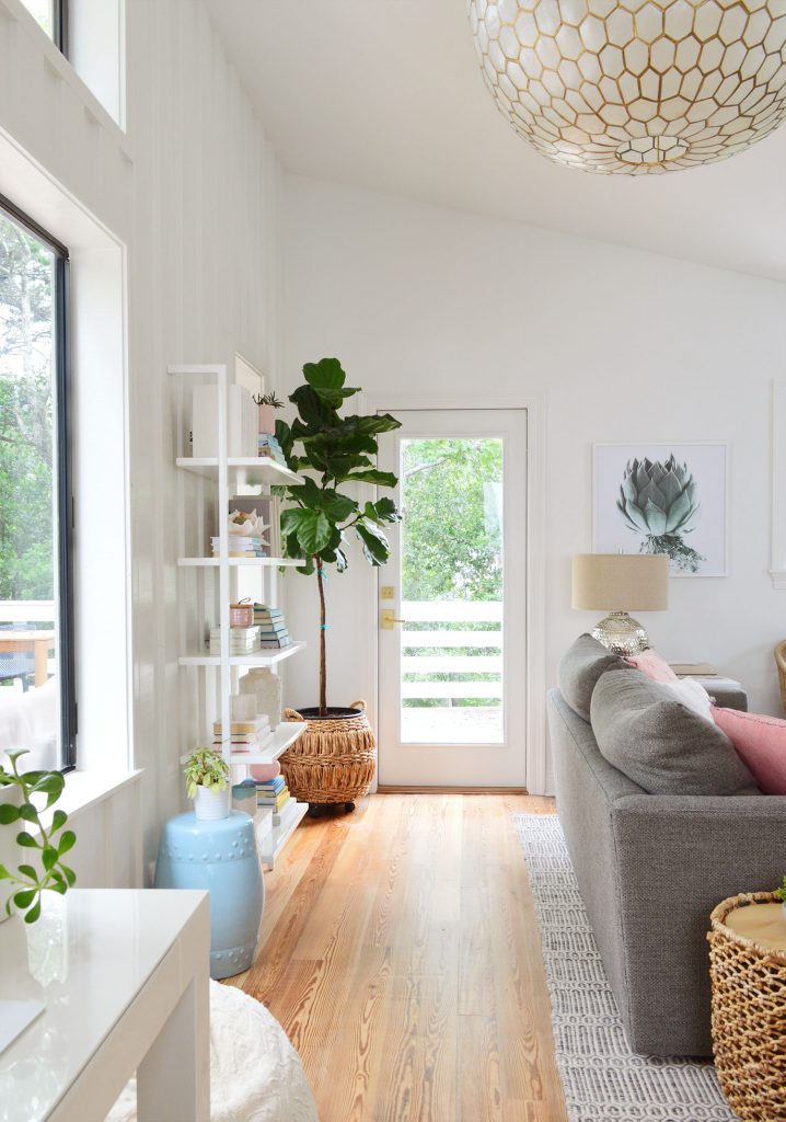 View Of Door To Deck Behind Couch With Large Capiz Light Fixture Overhead