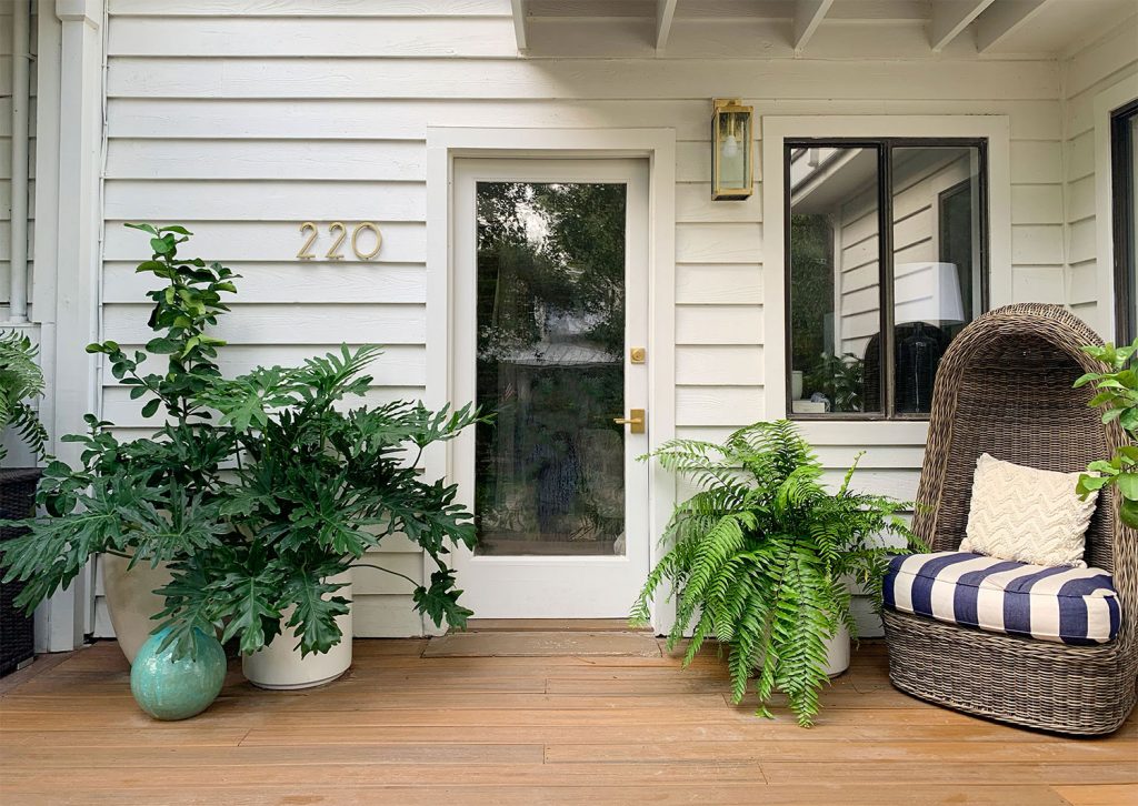 Front Porch With Glass Door And Lots Of Plants