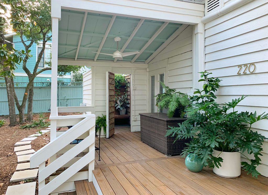 Covered Porch Area With Tropical Plantings Storage Bin And Outdoor Shower