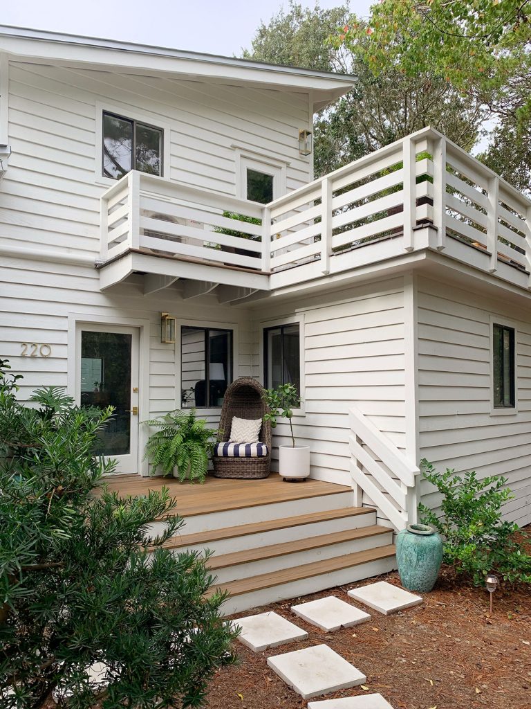 Two Levels Of Porches On White House With Horizontal Railings