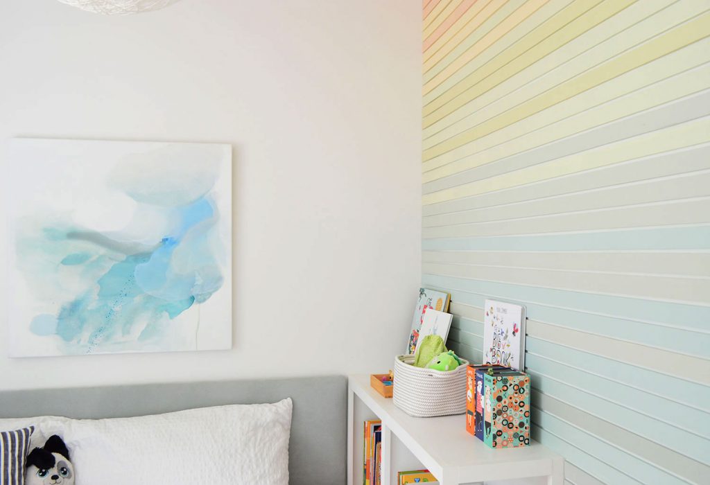 Abstract Blue Painting Next To Rainbow Stripe Wall Treatment