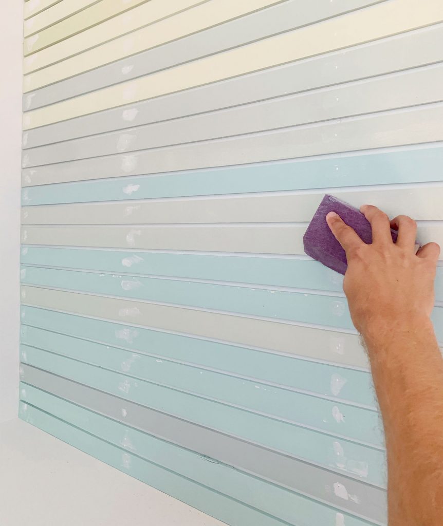 Hand Sanding Spackled Holes On Striped Wall Treatment