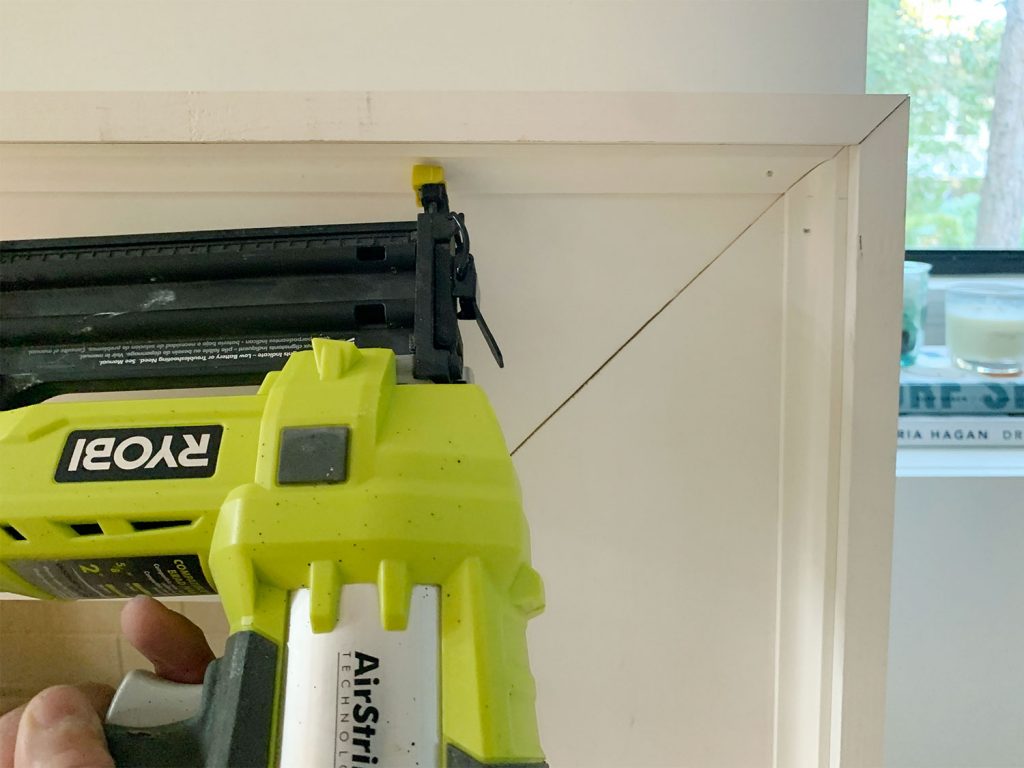 Nail Gun Securing Small Corner Trim Piece Along Inside Edge Of Mantel