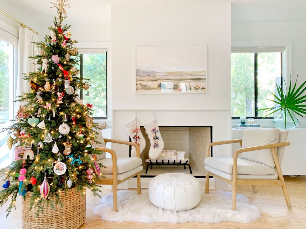 Bedroom fireplace scene with Christmas tree chairs and stockings