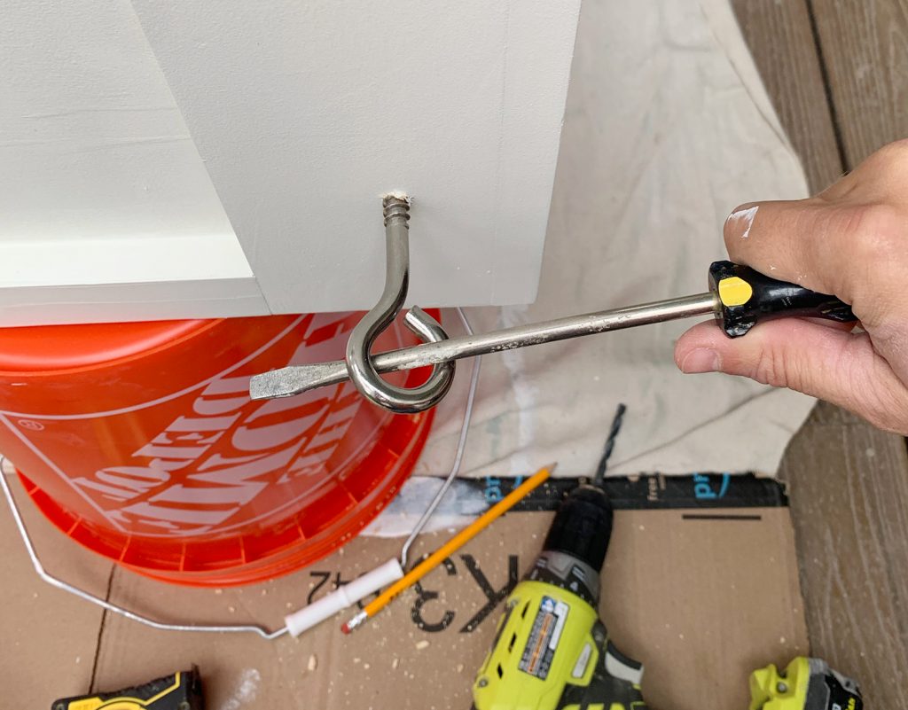 Turning eyehook in hanging daybed using long screwdriver