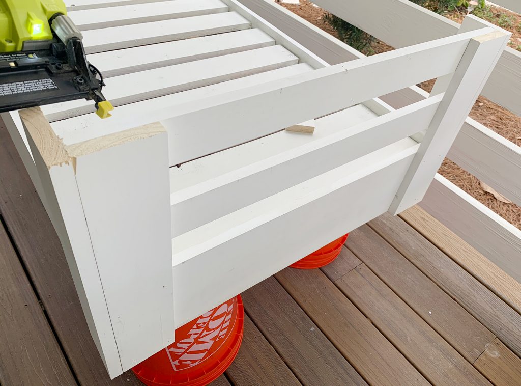 Attaching upper horizontal rail connected two corner pieces
