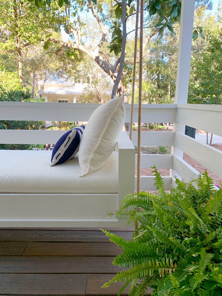 Side View Of Finished White Hanging Daybed With Cream Cushion