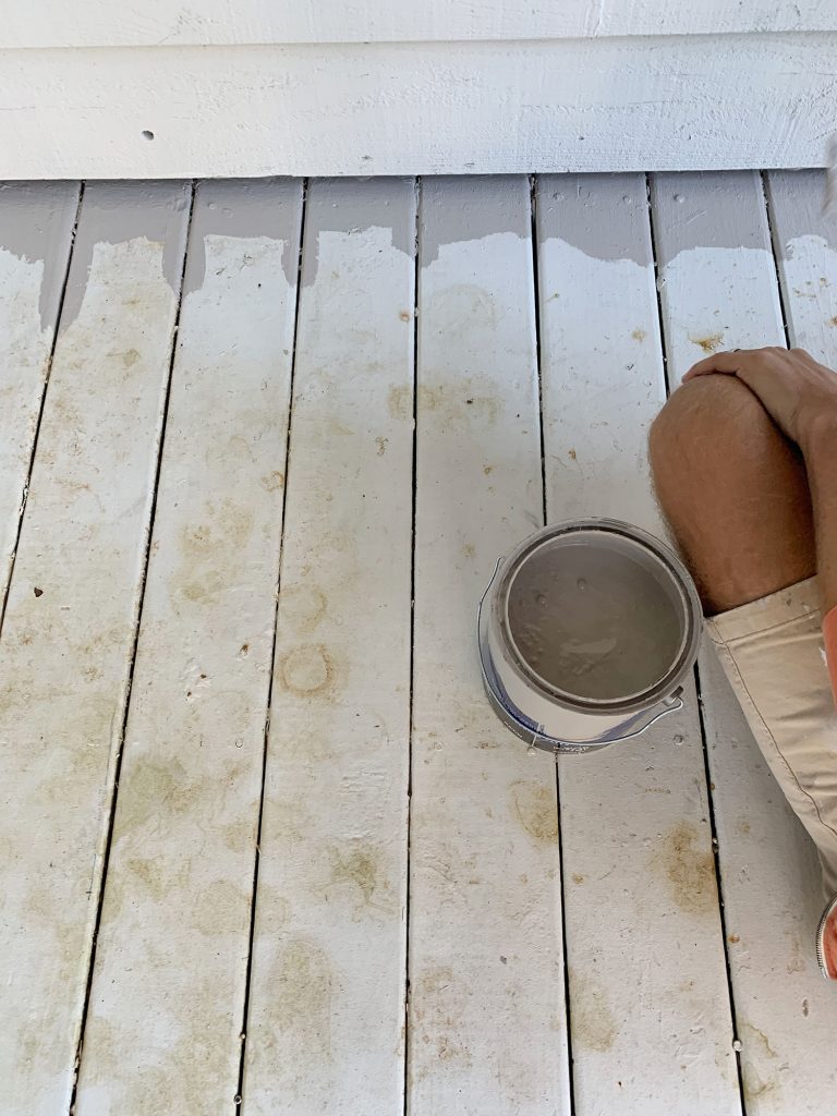 White painted porch floor stained with leaf marks