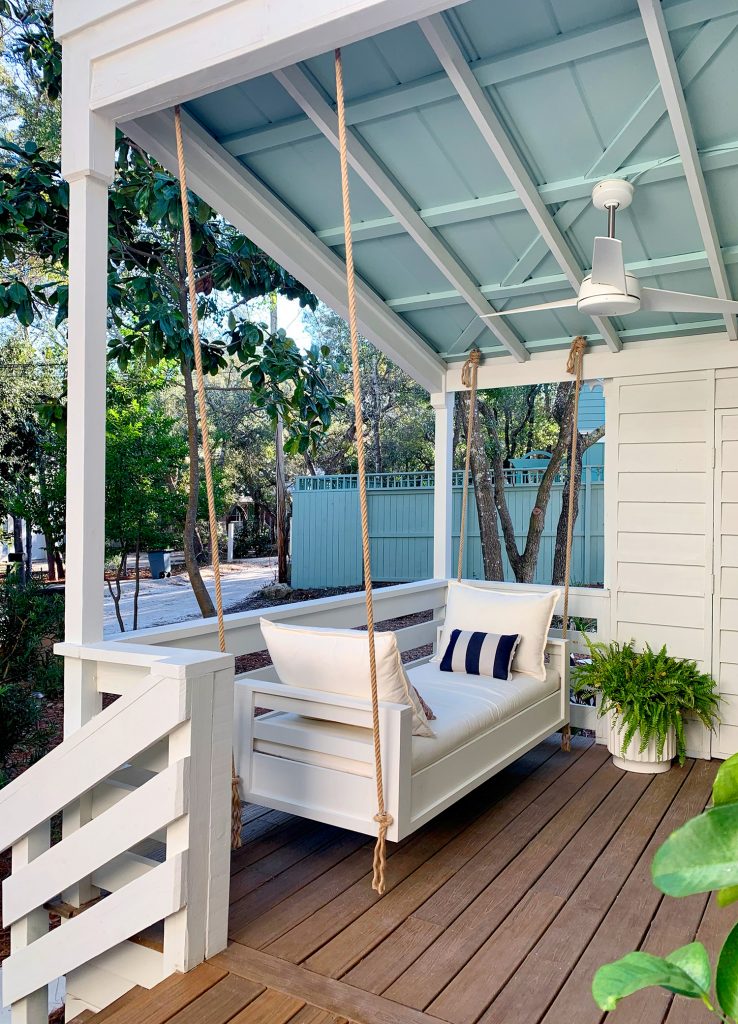 Outdoor Hanging Daybed Hung With Rope In Four Spots Under Covered Porch Ceiling