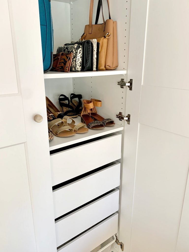 View inside Ikea Pax wardrobe with shoes and purses