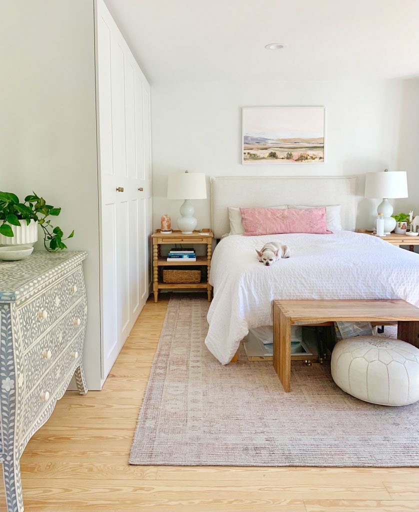 White beachy bedroom with ikea pax wardrobe closets along one wall