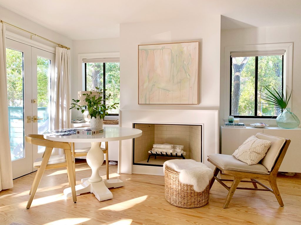 Seating area in bedroom in front of fireplace with DIY mantle