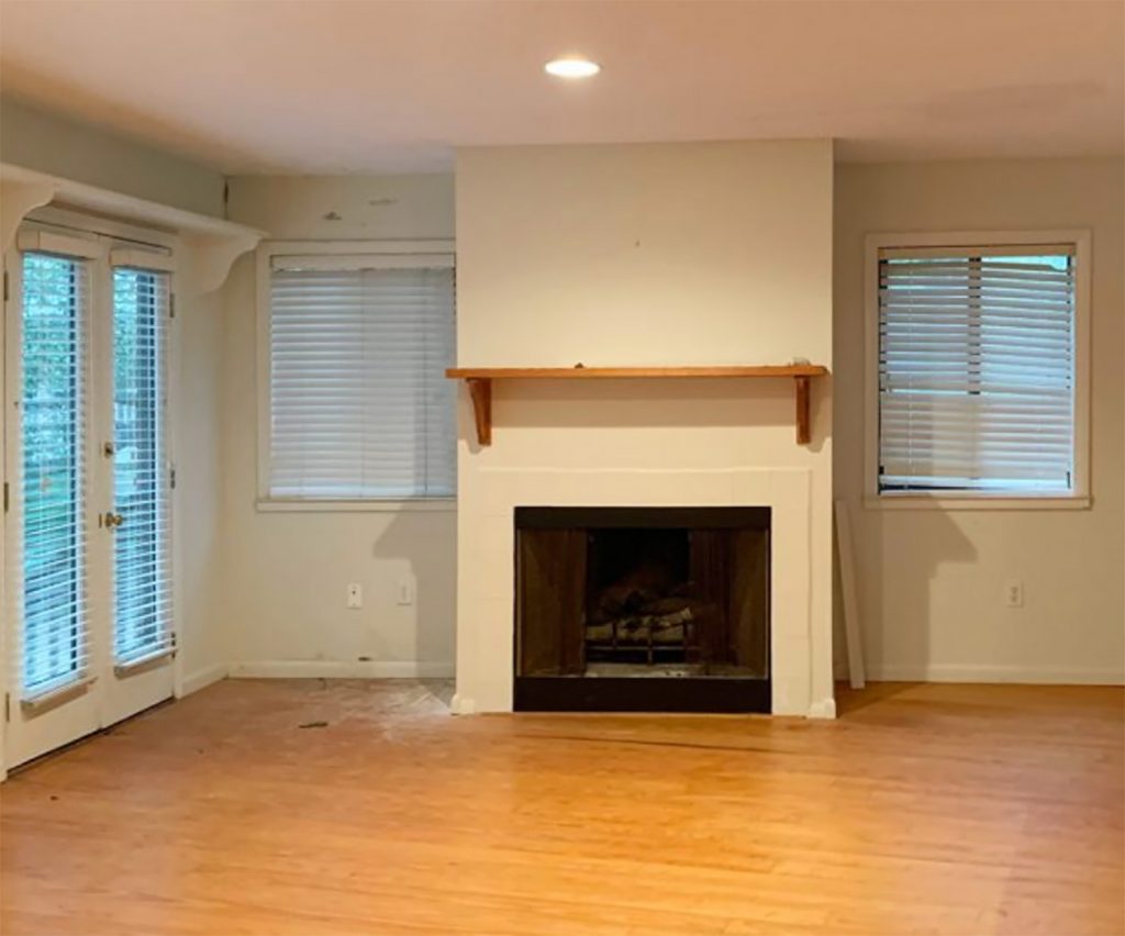 Before photo of fireplace in living room with broken blinds and shelf