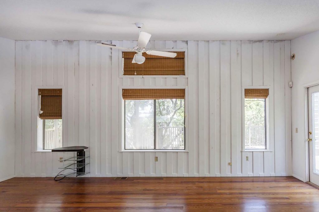 Before Photo of Upstairs Family Room With Moldy Walls And White Panelings