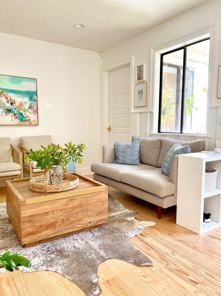 Kitchen Sitting Area With Gray Loveseat Wood Coffee Table Cowhide Rug And Storage Cubby