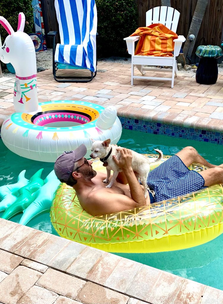 Burger standing on John in pineapple pool float