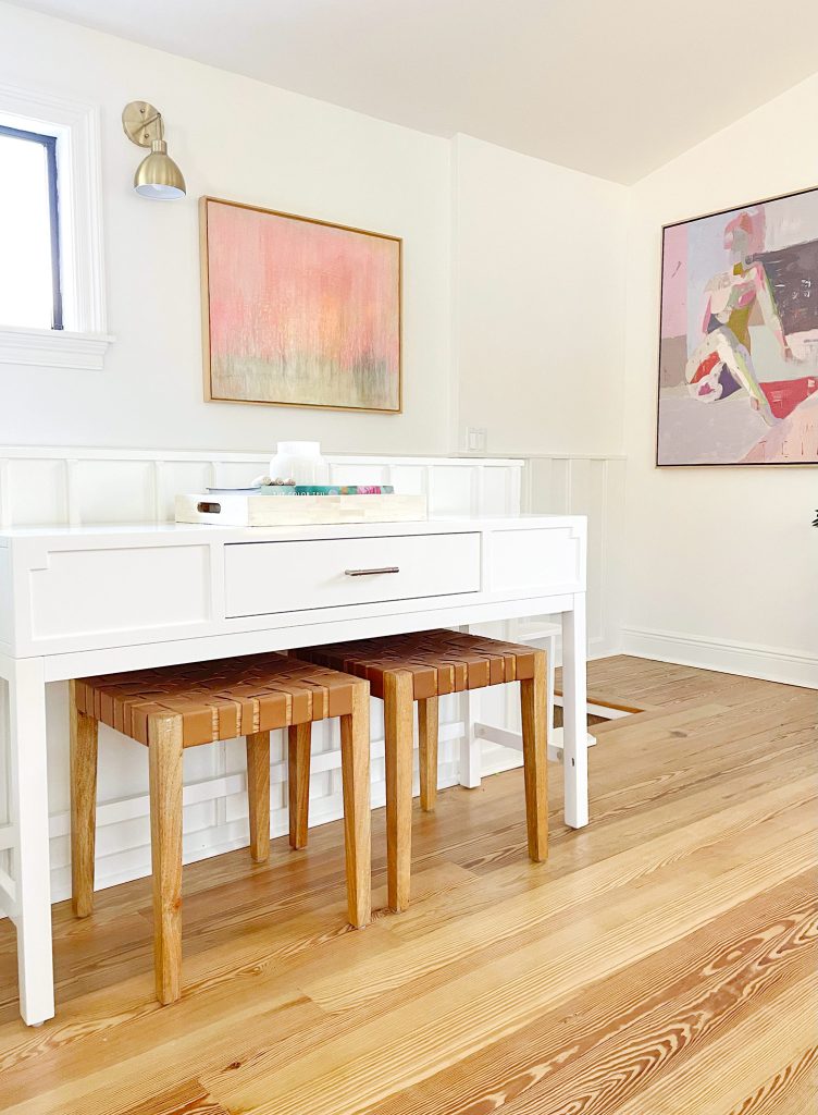 Console Table In Upstairs Modern Family Room With Leather Benches And Framed Painting Artwork In Background