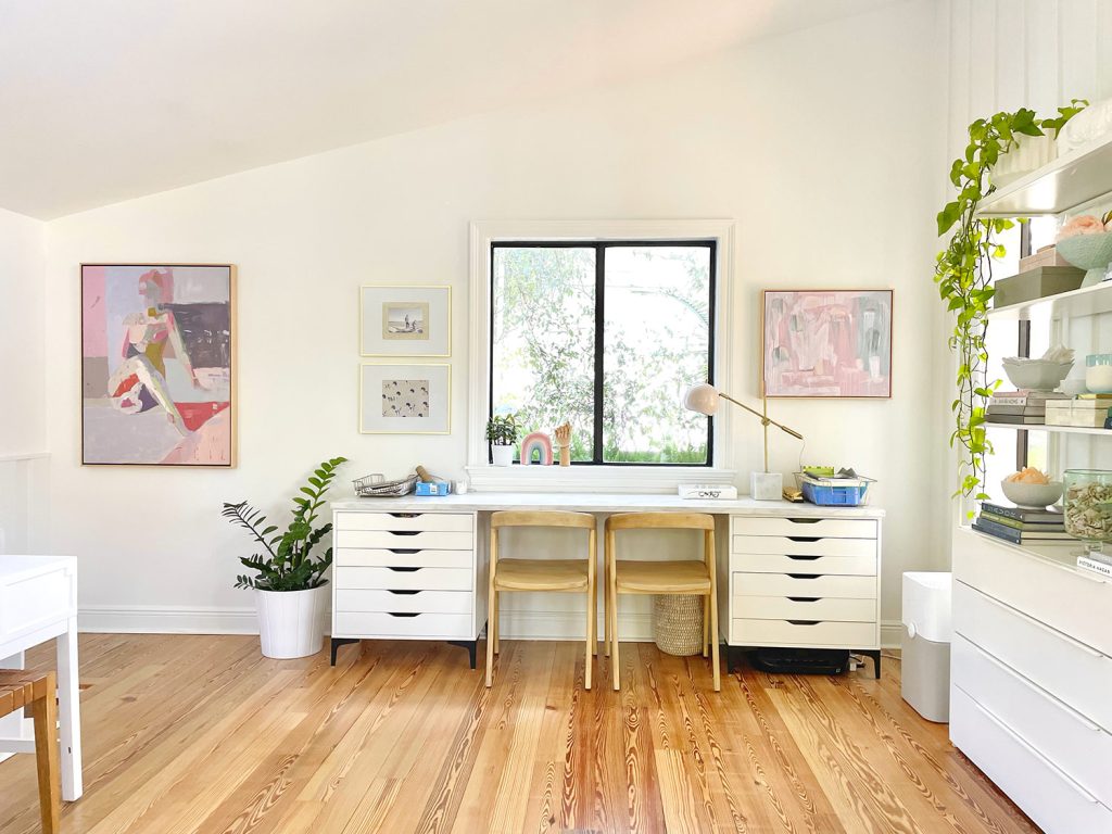 Kids Art Desk Under Window In Open Modern White Family Room With Faulted Ceilings And Artwork