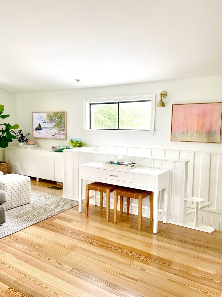 Console Table By Stairs In Upstairs Modern Family Room With White Paneled Wainscoting