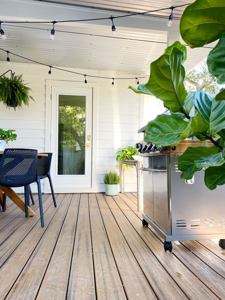 Empty space on porch for easy passage between table and grill to new door in house