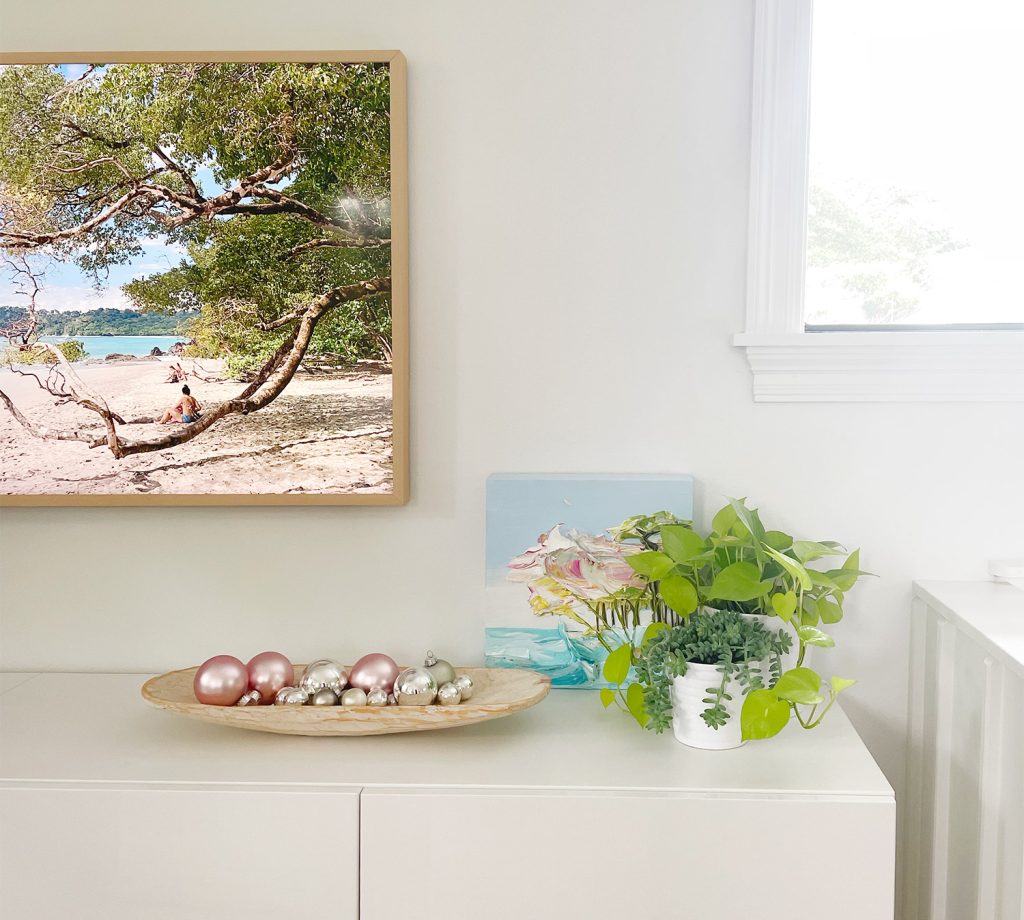 Shallow dish of ornaments as tabletop decor on media console